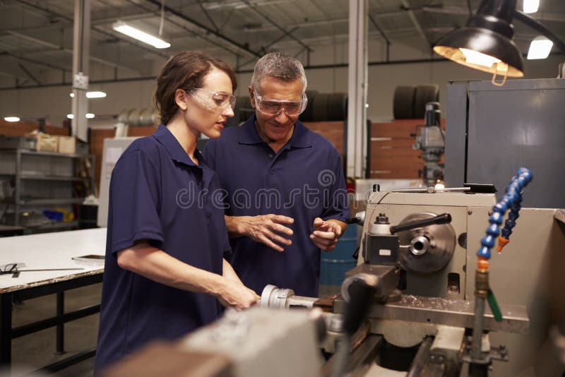 Engineer Training Female Apprentice On Milling Machine stock photo