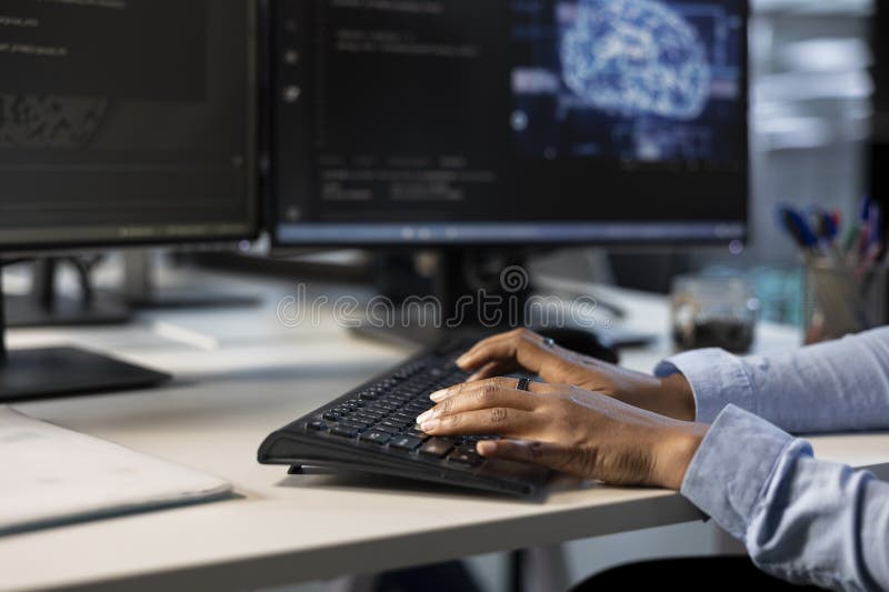 Engineer typing on keyboard in server hub, close up stock images
