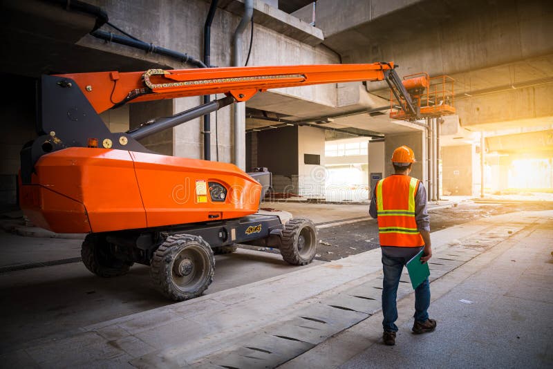 A engineer under inspection and checking construction process railway ,straight Boom Lift to construction roof on sky rail train b