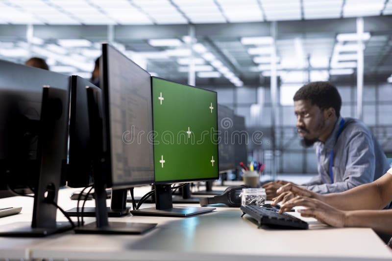 Engineer Using Green Screen PC in Server Hub To Shield Data Stock Photo ...