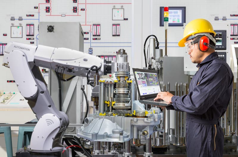 Engineer using laptop computer for maintenance robotic industry royalty free stock photography Engineer using laptop computer for maintenance robotic industry royalty free stock photography