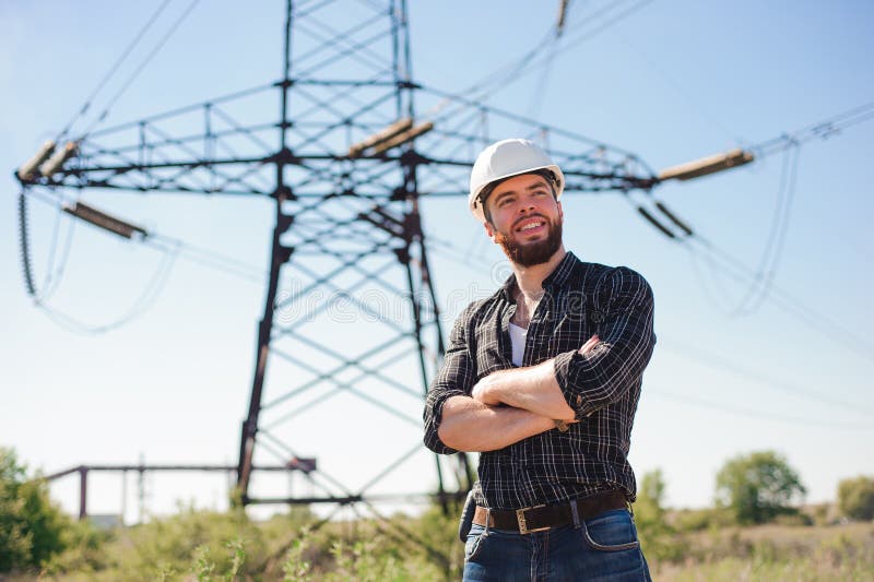 Engineer with White Hard Hat Under the Power Lines.Engineer Work at an