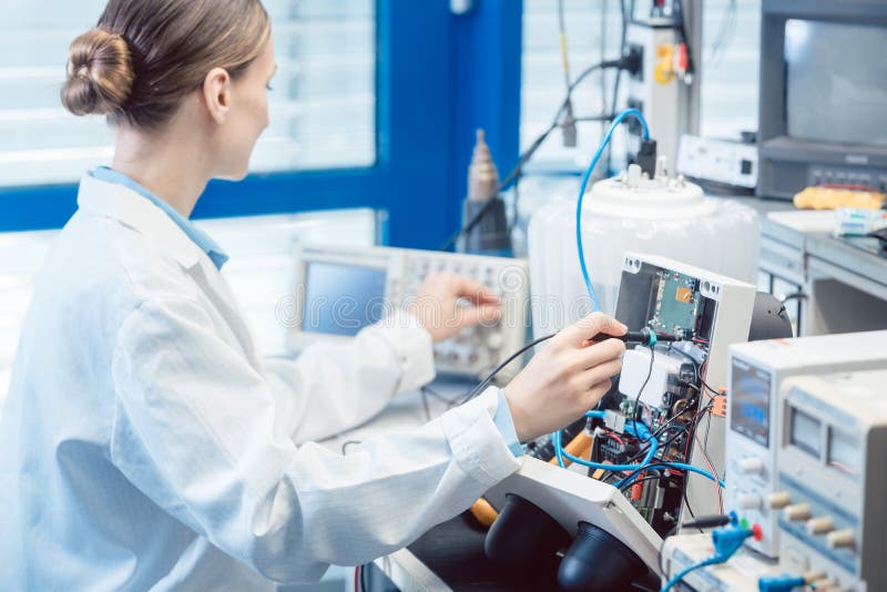 Engineer woman measuring electronic product on test bench