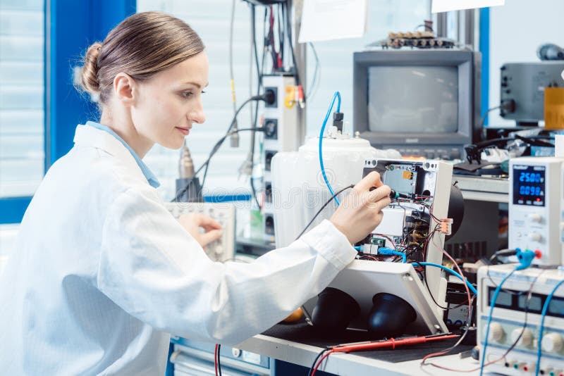 Engineer woman measuring electronic product on test bench