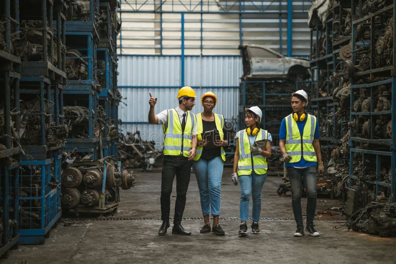 Engineer worker team together happy working in old grunge garage used auto part warehouse stock photography