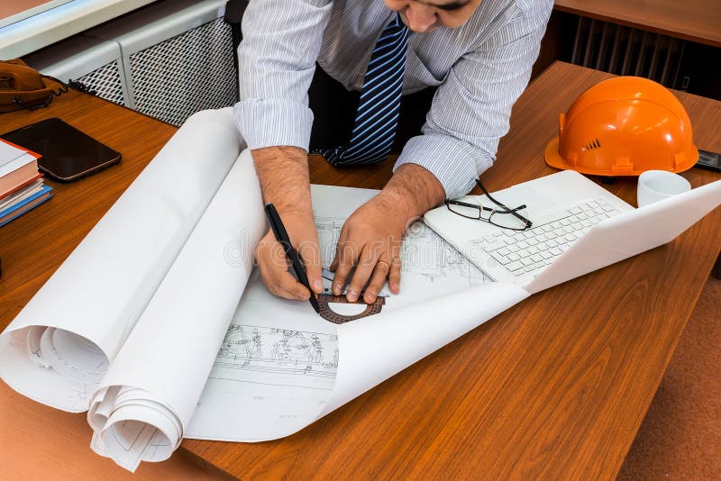 Engineer Working in the Office with the Drawings Stock Photo Image of