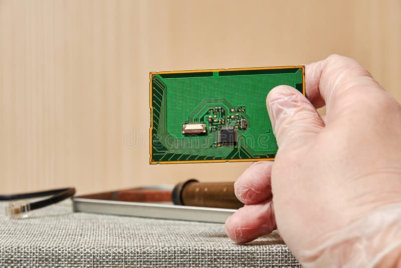 Engineer Working on a PCB with a Chip in the Laboratory Stock Image