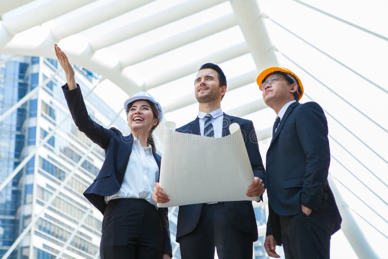 Engineering and architecture concept,engineers working on a building site holding a blueprints,architect man working with stock photos Engineering and architecture concept,engineers working on a building site holding a blueprints,architect man working with stock photos