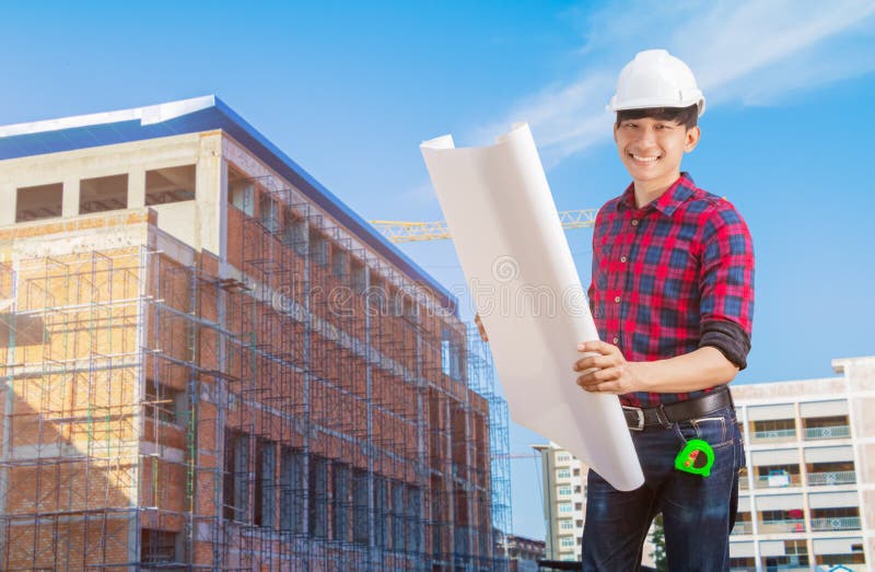 Engineering hold open blueprint in Construction site concept royalty free stock image