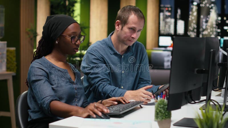 Engineering team typing complex code on computer, developing machine learning models to automate business tasks in workspace. Teamworking colleagues write programming language scripts on PC, camera B. Code programming video