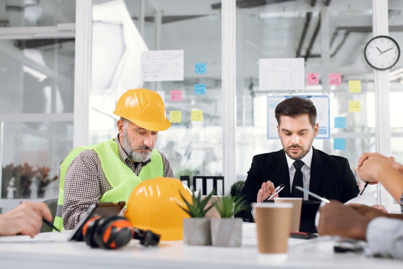 Engineers, designers and architects leading conference in modern office stock photos