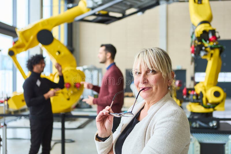 Engineers discussing robotics development in a modern industrial setting stock images