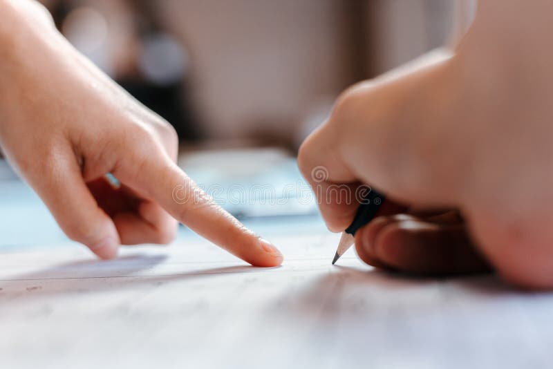 Engineers holding a pen pointing to a building and  drawing outlay construction plan as guide for builders with details. Engineer