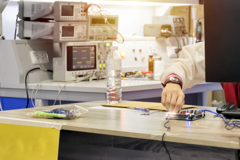 Engineers are innovating on innovation. The background is a large machine. Adjusting for the right fit. Computer programming for use in the workplace.