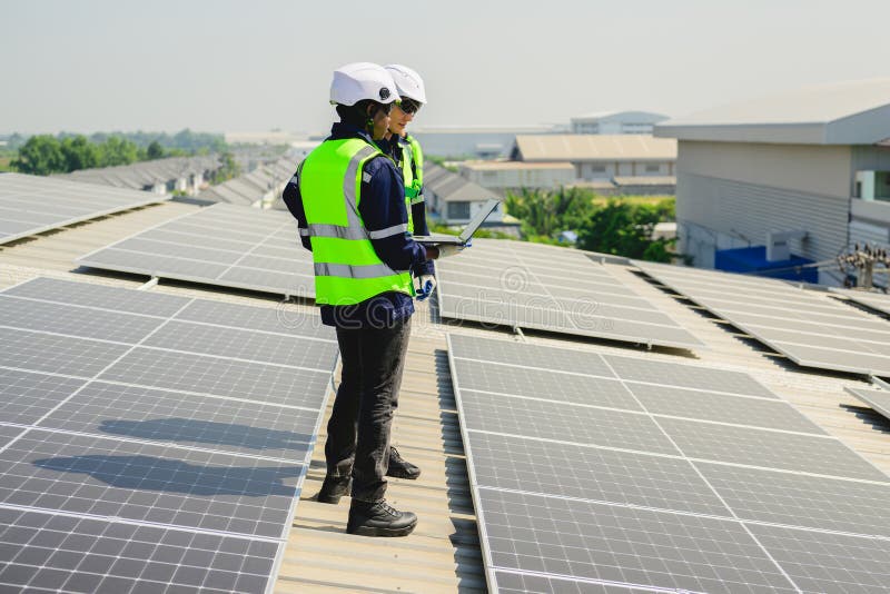 Engineers with Safety Helmet Checking Solar System at Solar Power Farm