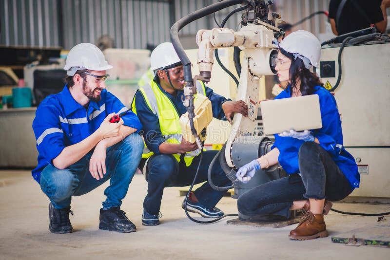 Engineers team mechanic using computer controller Robotic arm for welding steel in steel factory workshop. Industry robot stock photos