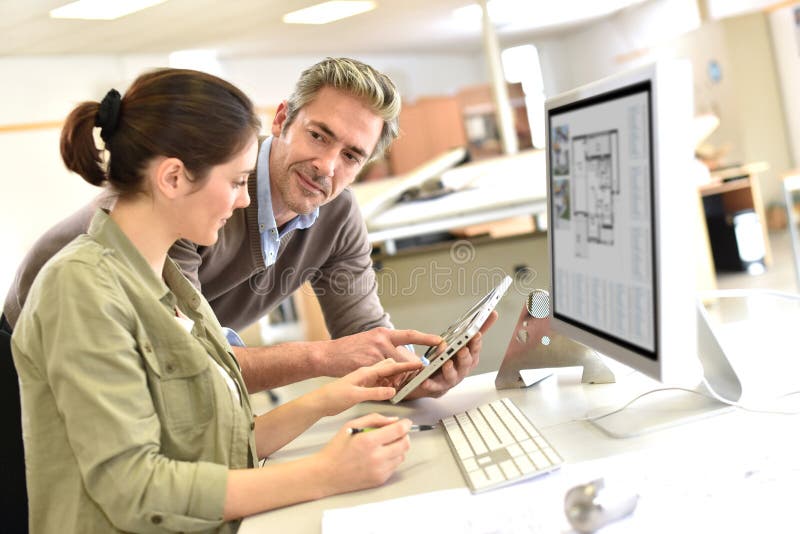 Engineers working with tablet and desktop at office royalty free stock photos