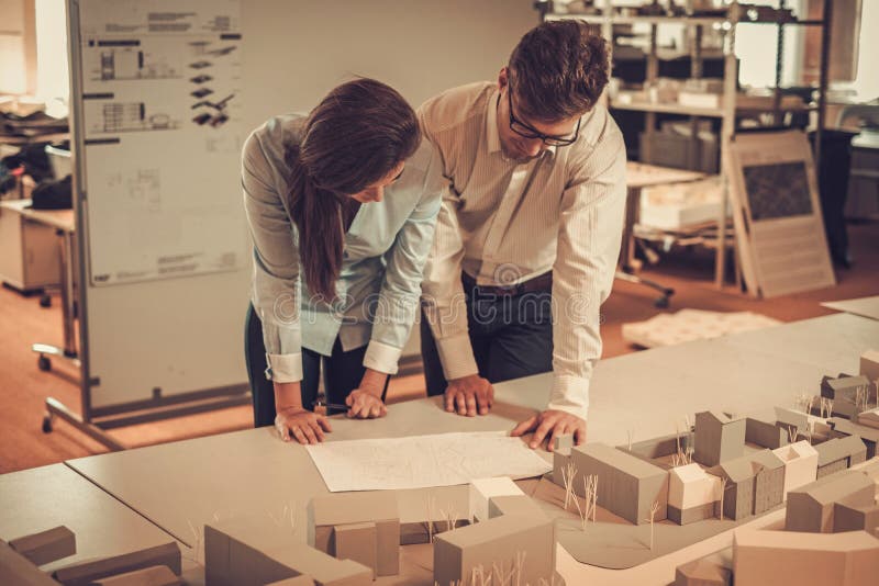 Engineers working together in a architect studio. stock photography