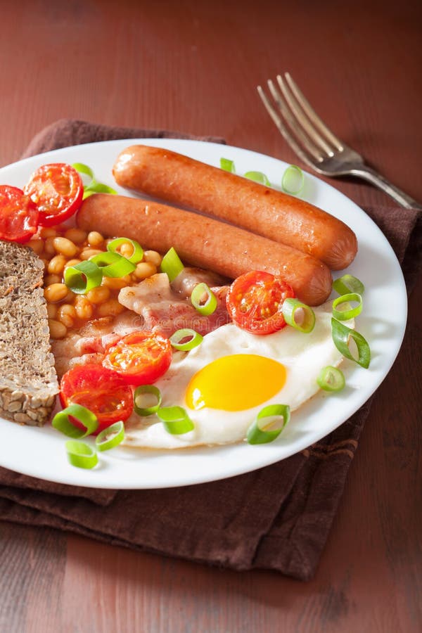 English Breakfast with Fried Egg Sausages Bacon Tomatoes Beans Stock