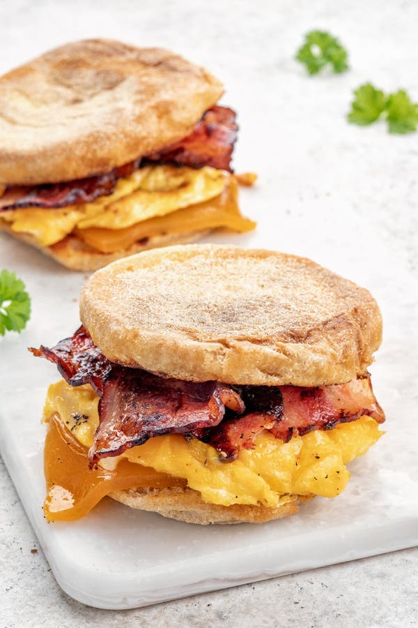 English Muffin, Egg, Ham, and Cheese Breakfast Sandwich on a Cutting