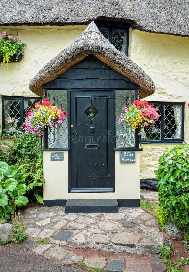 Traditional thatched cottage pub with bed and breakfast accommodation in an English village. Devon, England. Traditional thatched cottage pub with bed and breakfast accommodation in an English village. Devon, England.