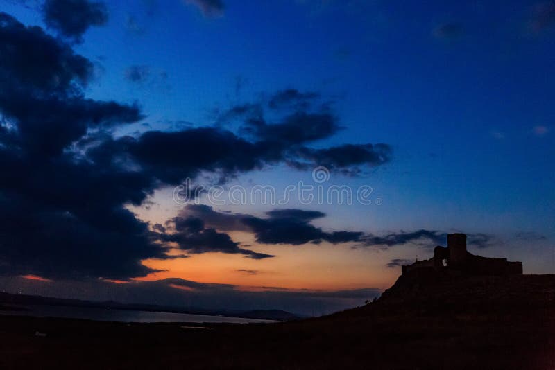 Enisala Fortress in Tulcea, Romania - view at sunset. The ruins of the old Enisala Fortress in Tulcea, Romania Sarichioi - shot at sunset