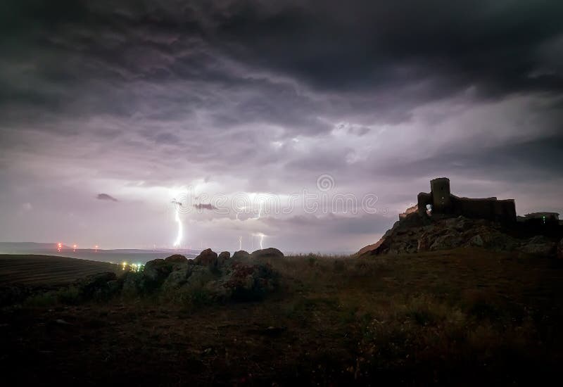 Enisala Medieval Fortress also referred as Heracleea Fortress on stormy weather, with Razim lake in the background in Tulcea county, Dobrogea region, Romania