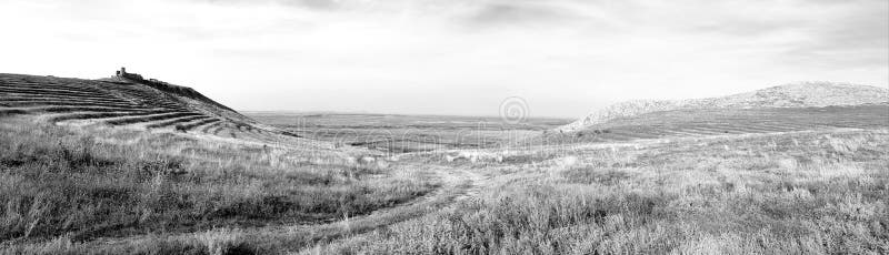 A view of hills and valleys next to Enisala Yeni-Sale Enisala, Enișala, Eraclea or Herakleia fortress in Dobrogea, close to the Black sea, an ancient greek stronghold. The citadel was built on an ancient Dacian site and was a strong presence, inhabited during various times Greek, Byzantium, Otoman etc. A view of hills and valleys next to Enisala Yeni-Sale Enisala, Enișala, Eraclea or Herakleia fortress in Dobrogea, close to the Black sea, an ancient greek stronghold. The citadel was built on an ancient Dacian site and was a strong presence, inhabited during various times Greek, Byzantium, Otoman etc..