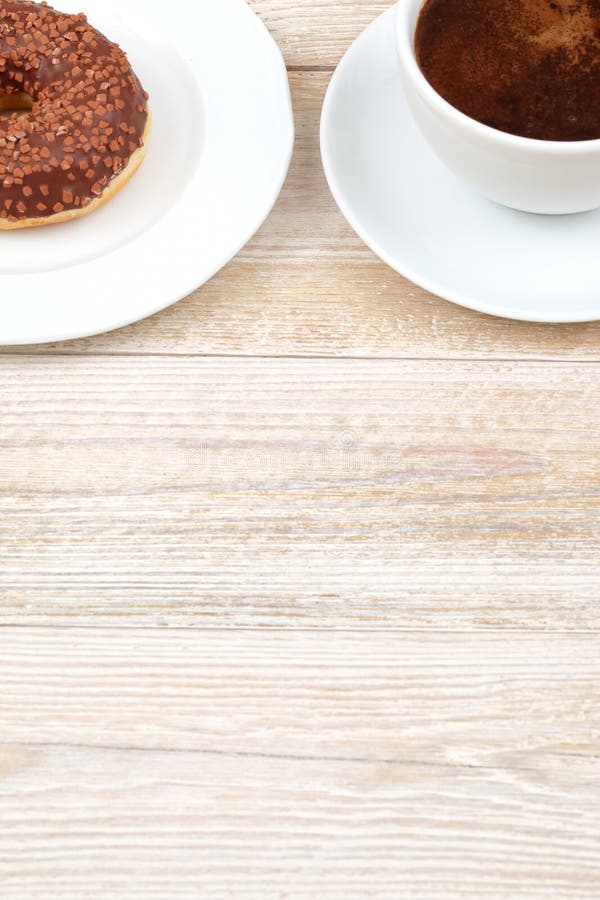 Enjoy the Coffee and Donut Delight placed beautifully on a Rustic Wooden Table setting royalty free stock images