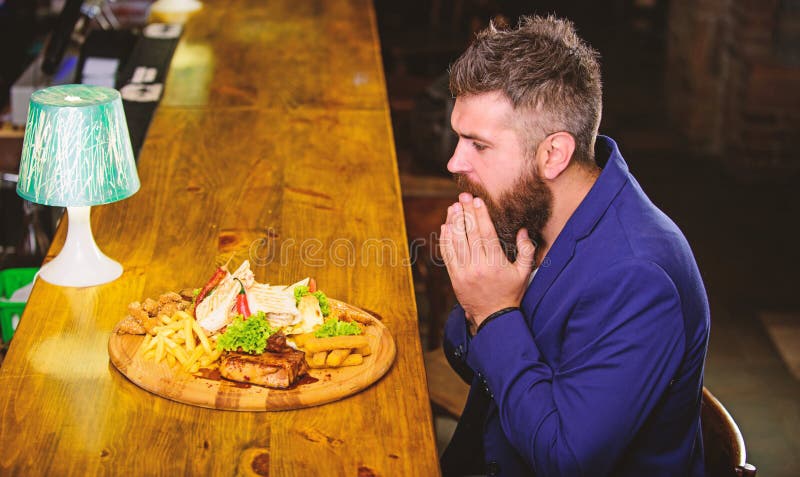 Enjoy meal. He deserve delicious meal. High calorie snack. Relax after hard working day. Businessman formal suit sit at royalty free stock images Enjoy meal. He deserve delicious meal. High calorie snack. Relax after hard working day. Businessman formal suit sit at royalty free stock images
