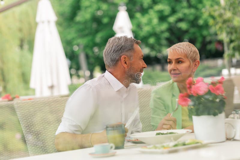 Couple of mature husband and wife enjoying breakfast outside stock photos Couple of mature husband and wife enjoying breakfast outside stock photos