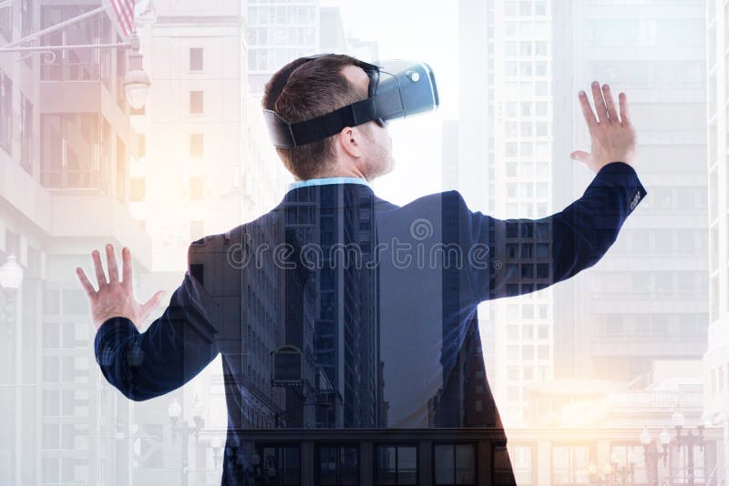 Back View Of Businessman Wearing Vr Headset And Spreading Hands Stock