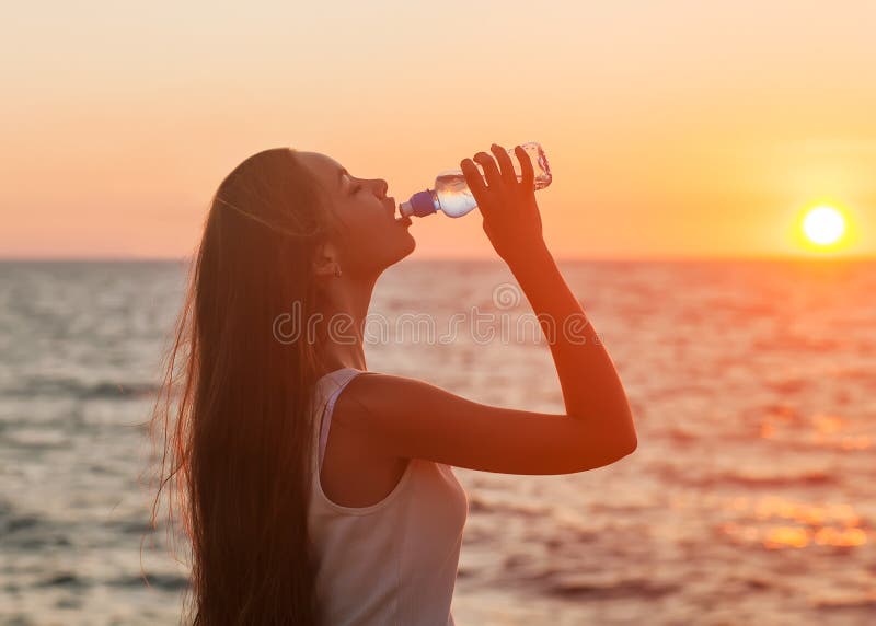 Enjoyment - free happy woman enjoying sunset.