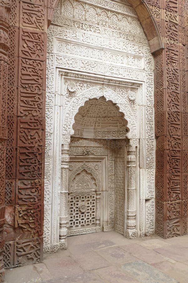 Intricate carvings on the mihrab of the Tomb of slave dynasty sultan Iltutmish from 13th century, Qutb Minar complex, Delhi, India. Intricate carvings on the mihrab of the Tomb of slave dynasty sultan Iltutmish from 13th century, Qutb Minar complex, Delhi, India