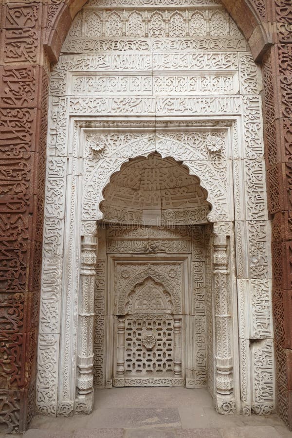 Intricate carvings on the mihrab of the Tomb of slave dynasty sultan Iltutmish from 13th century, Qutb Minar complex, Delhi, India. Intricate carvings on the mihrab of the Tomb of slave dynasty sultan Iltutmish from 13th century, Qutb Minar complex, Delhi, India