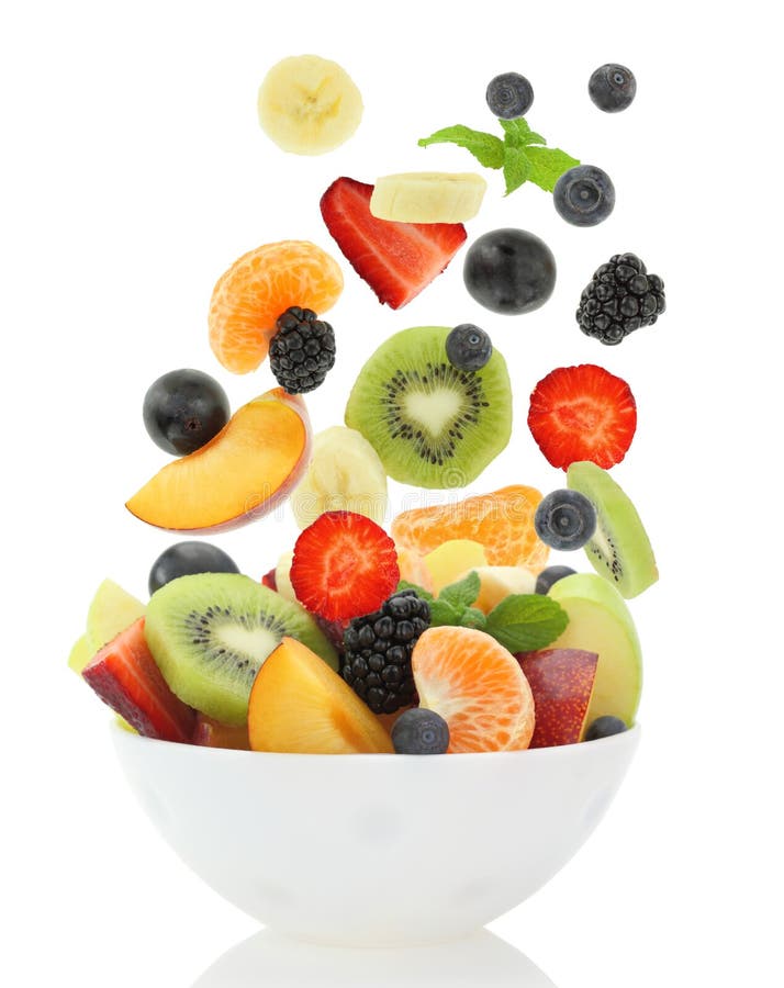 Fresh mixed fruit salad falling into a bowl of salad on white background. Fresh mixed fruit salad falling into a bowl of salad on white background