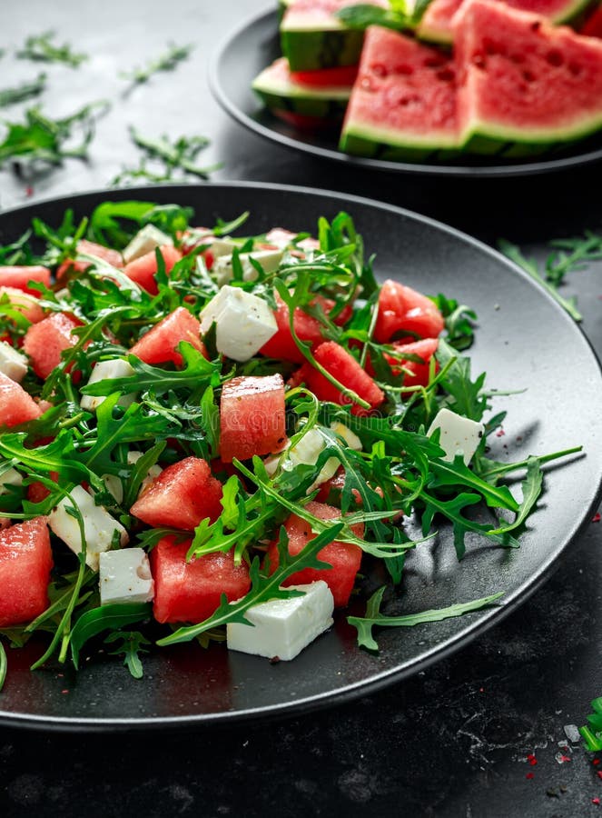 Ensalada jugosa del queso Feta del arugula de la sandía con la menta y anaranjado frescos, preparación del limón Plato del verano imágenes de archivo libres de regalías Ensalada jugosa del queso Feta del arugula de la sandía con la menta y anaranjado frescos, preparación del limón Plato del verano imágenes de archivo libres de regalías