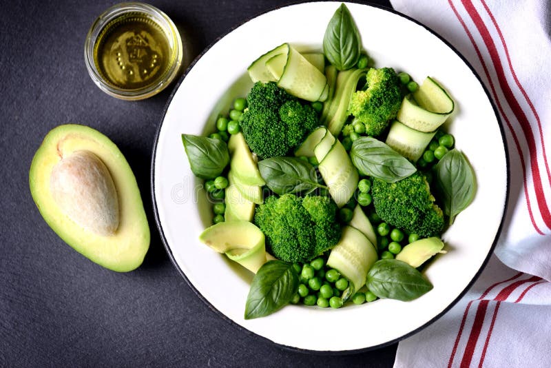 Ensalada sana del bróculi, de guisantes verdes, del pepino y del aguacate con albahaca y aceite de oliva Alimento sano Visión sup foto de archivo libre de regalías Ensalada sana del bróculi, de guisantes verdes, del pepino y del aguacate con albahaca y aceite de oliva Alimento sano Visión sup foto de archivo libre de regalías