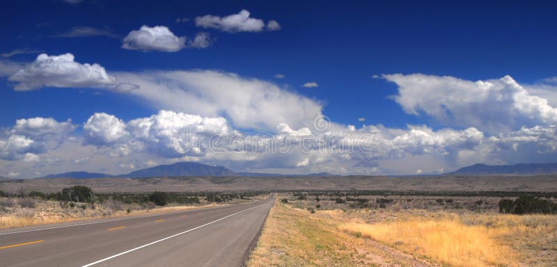 Desolate stretch of road in rural New Mexico with dramatic sky. Desolate stretch of road in rural New Mexico with dramatic sky