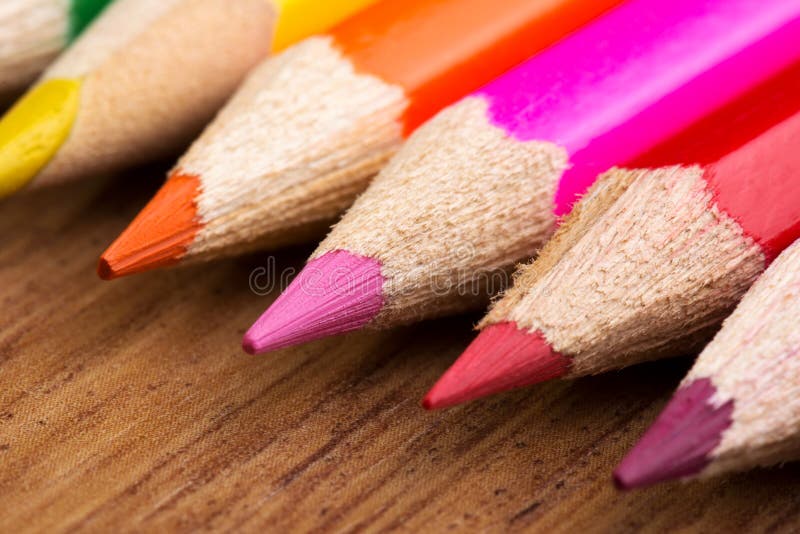 Colored pencils on wood background. Colored pencils on wood background