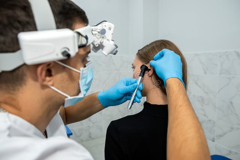 Ent Doctor Examines The Patientand X27s Ear Using An Otoscope Stock