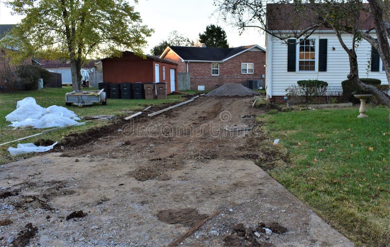 Part of a photo series illustrating the steps of the removal of a residential aggregate driveway in poor shape  and replacing it with a new concrete driveway  including the parking apron. Part of a photo series illustrating the steps of the removal of a residential aggregate driveway in poor shape  and replacing it with a new concrete driveway  including the parking apron.