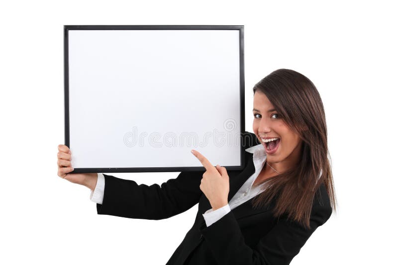 Enthusiastic businesswoman pointing at blank picture frame. Enthusiastic businesswoman pointing at blank picture frame