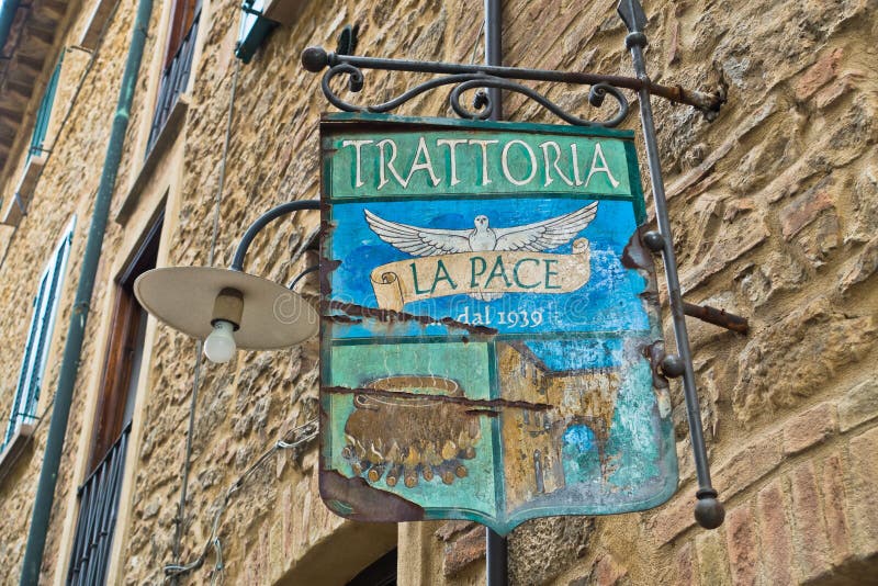 Entrance to very old trattoria in medieval building, a detail from the streets from Voltera, Tuscany