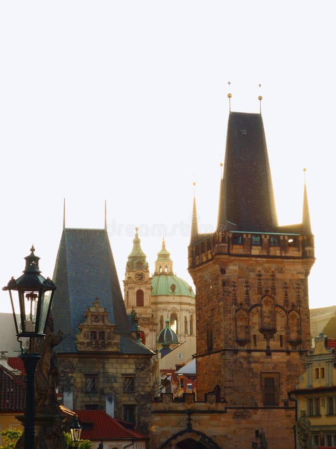 Entrance towers of Charles Bridge with St.Nicholas Cathedral.Prague, Czech Republic