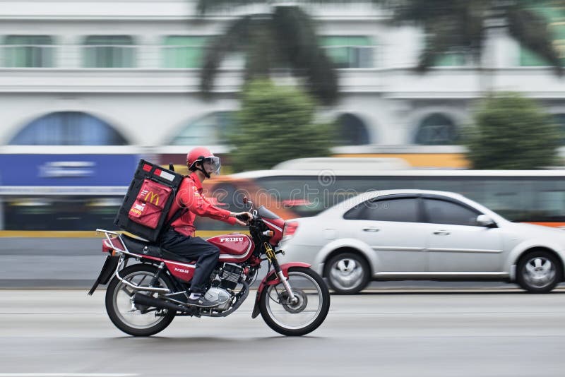 GUANGZHOU – FEB. 22, 2012. McDonald delivery motorcycle on Feb. 22, 2012. It took McDonald 19 years to reach 1,000 restaurants in China and the company plans to double the number to 2,000 by 2013. GUANGZHOU – FEB. 22, 2012. McDonald delivery motorcycle on Feb. 22, 2012. It took McDonald 19 years to reach 1,000 restaurants in China and the company plans to double the number to 2,000 by 2013.