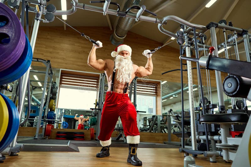 Culturista De Santa Claus En El Gimnasio En La Navidad Foto de archivo
