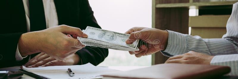 Entrepreneurs are receiving money that is a bribe of their partners with both of whom are corrupt in the company room. stock images Entrepreneurs are receiving money that is a bribe of their partners with both of whom are corrupt in the company room. stock images