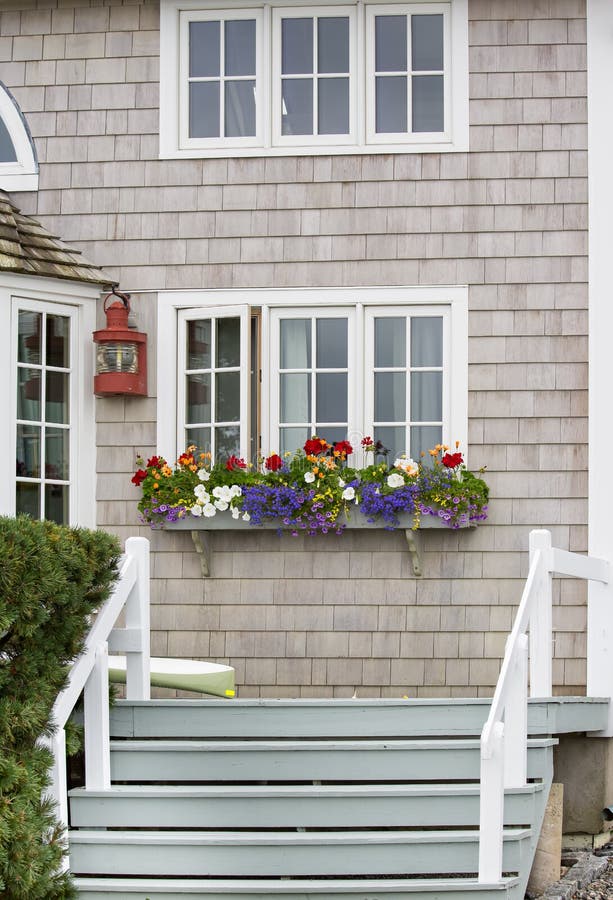 The entrance to this home is very friendly looking with the planter full of bright flowers. The entrance to this home is very friendly looking with the planter full of bright flowers.