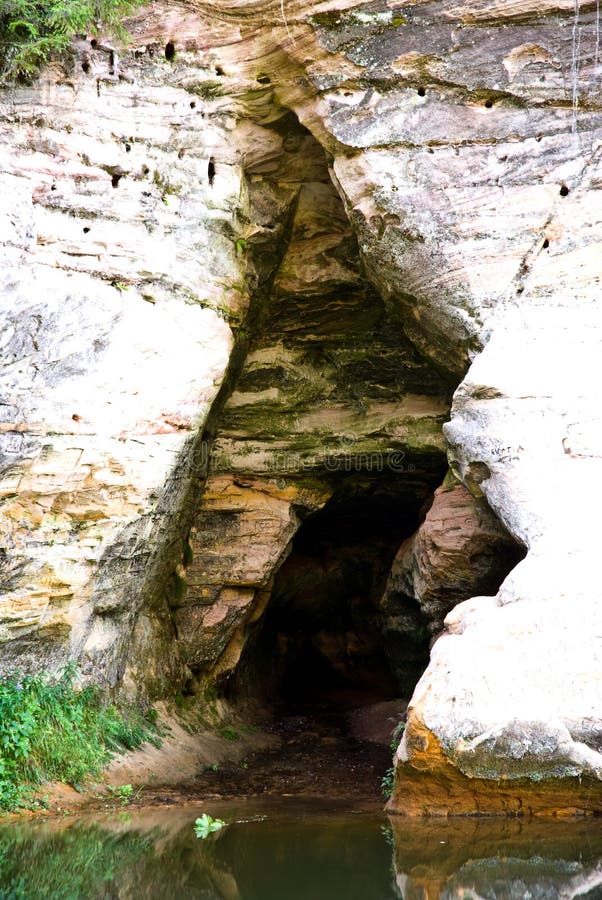 A picture of the entrance to a natural cave in Taevaskoja, Estonia. This is the highest such cliff in Estonia at over 20m in height. A picture of the entrance to a natural cave in Taevaskoja, Estonia. This is the highest such cliff in Estonia at over 20m in height.